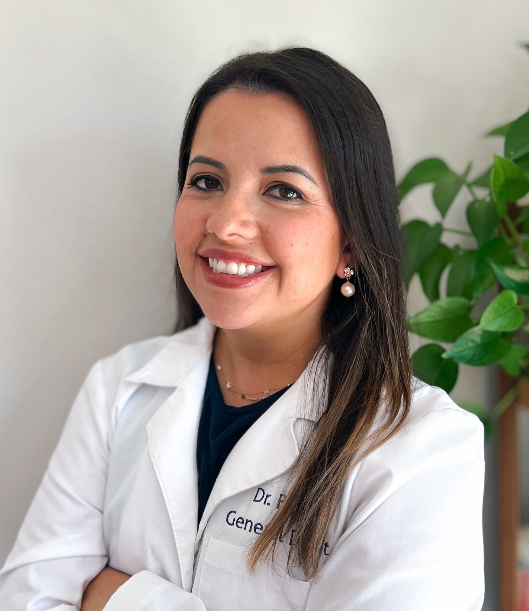 Smiling woman in a white lab coat.